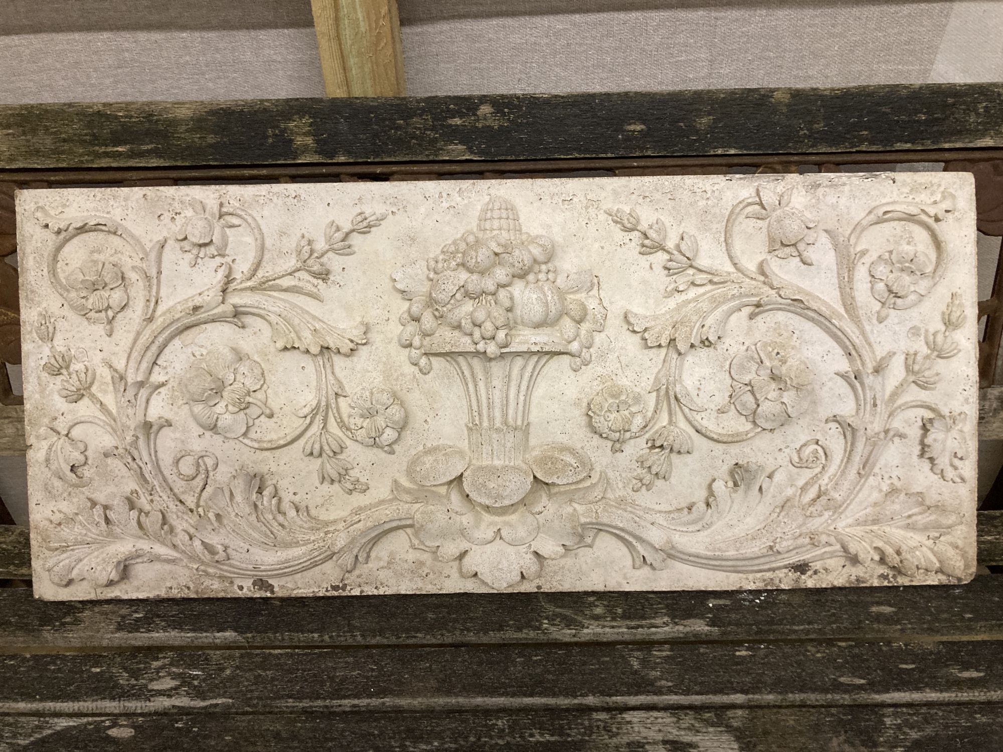 Three reconstituted stone and plaster wall plaques, largest 94 x 40cm